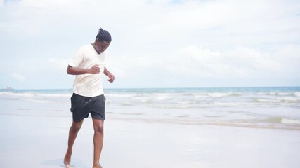 Young African man barefoot running exercise on tropical beach. Healthy guy sportsman enjoy outdoor active lifestyle sport training fitness workout jogging at seaside. Wellness healthcare motivation.