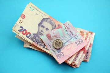 Ukrainian money bills on light blue paper background
