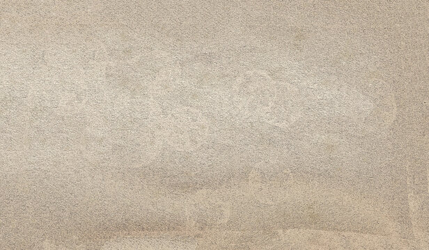 Beige textured wall with grunge streaks creating an abstract background