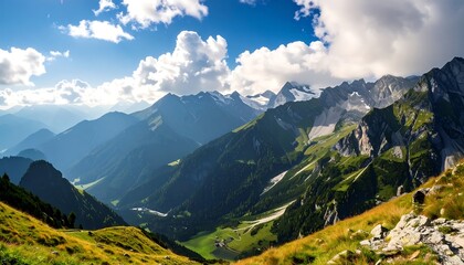 Obraz premium A breathtaking vista of a sun-drenched alpine landscape showcases rugged mountains, vibrant greenery, and a clear blue sky.