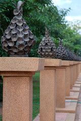 Thai patterned sculptures on pillars, lined up