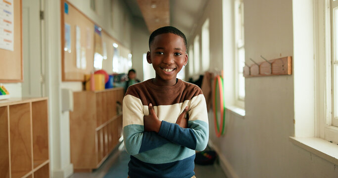 Black child, portrait or smile in hallway for education, learning opportunity or back to school. Kid, arms crossed or happy at montessori for development, growth and knowledge or scholarship in Kenya
