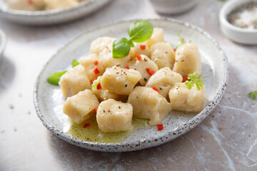 Homemade potato gnocchi with basil and chilli