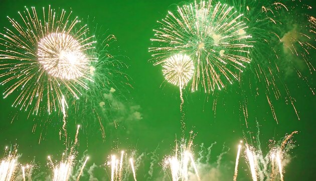 Golden Fireworks Exploding Against Vibrant Green Night Sky