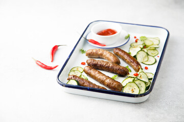 Homemade grilled sausages with cucumber salad