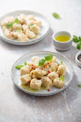 Homemade potato gnocchi with basil and chilli