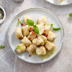 Homemade potato gnocchi with basil and chilli
