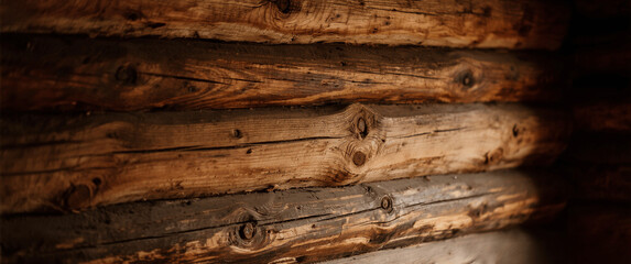 Detailed view of vintage wooden log wall with natural grain, knots.