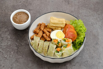 Gado Gado, Indonesian traditional vegetable salad with peanut sauce, rice cake, tofu, tempeh and egg