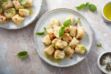 Homemade potato gnocchi with basil and chilli