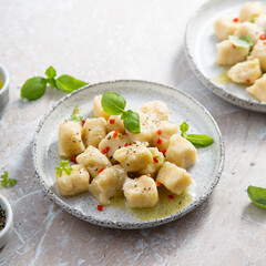 Homemade potato gnocchi with basil and chilli