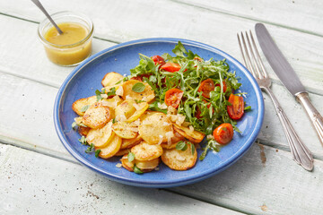 Herb roasted potatoes with arugula salad