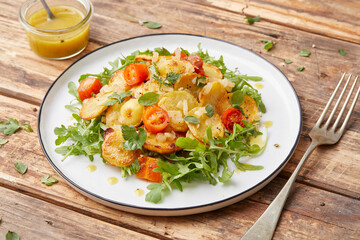 Herb roasted potatoes with arugula salad