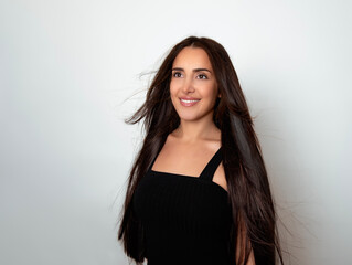 Fototapeta premium Beautiful young woman with long dark hair and happy smile