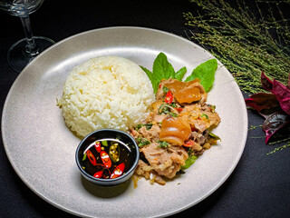Stir-fried seafood with holy basil served over rice, a spicy and aromatic Thai street food dish packed with shrimp, squid, and fish.