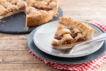 Slice of traditional Pastafrola pie with guava filling, also known as Cuban pae on rustic wooden table. Copy space	
