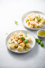 Homemade potato gnocchi with basil and chilli