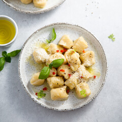 Homemade potato gnocchi with basil and chilli