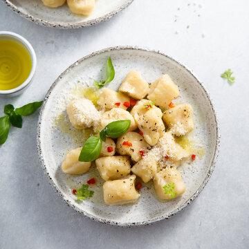 Homemade potato gnocchi with basil and chilli