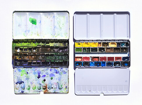 Old and new watercolor paintboxes side by side for art comparison