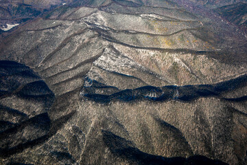 Aerial view. Golden autumn in Primorsky Krai. The Sikhote-Alin mountain range from above.