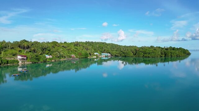 Maratua, Indonesia: Aerial drone footage showing reflection of the famous Maratua lagoon and island in the Derawan Archipelago in Borneo Indonesia