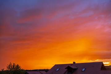 Colorful clouds fill the evening sky above an urban landscape in Bavaria Germany creating a scenic sunset city view blending architecture and natural beauty