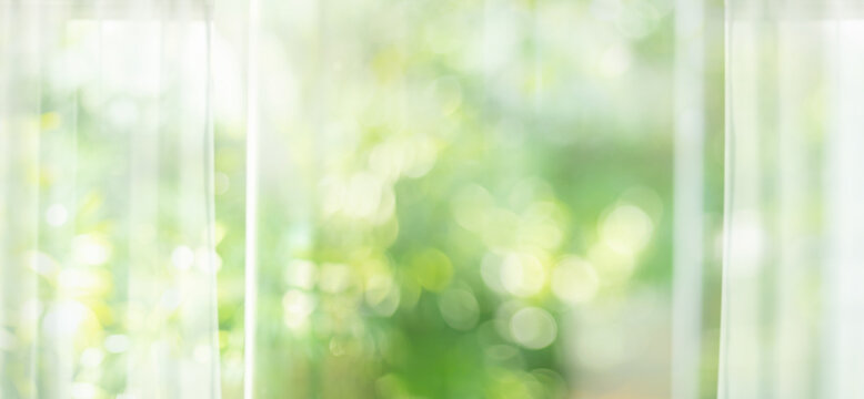 Big window glass building with soft blur curtain and green garden