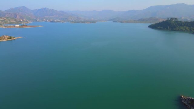 Aerial view of Khanpur Lake shows the vast water body surrounded by mountains and green vegetation, Khanpur, Khyber Pakhtunkhwa, Pakistan.
