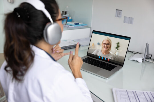 Elderly patient displaying on laptop screen during virtual consultation - Powered by Adobe