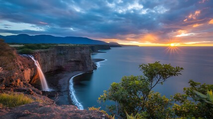 Spectacular sunset over the coast with waterfall cascading down the cliffs edge creating an amazing landscape and breathtaking scenery capturing the beauty and serenity of nature at its finest hour