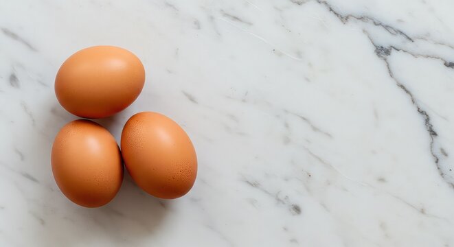 Fresh brown eggs on a marble surface ready for your healthy breakfast recipe or cooking project, showcasing natural simplicity and rustic charm for your culinary creations