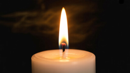 Glowing candle flame casting warm light and hope, perfect for memorial services or spiritual reflection