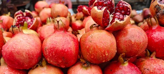 Close up shot of pile of fresh Raindrops on a pomegranate.