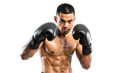 A muscular boxer poses in a fighting stance, wearing black gloves, showcasing determination and focus.