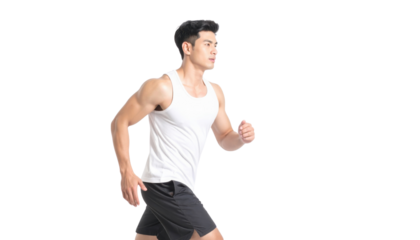 A fit man in a tank top is jogging, showcasing athleticism and movement.