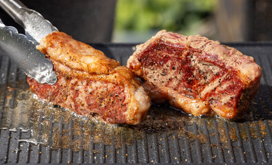 freshly grilled beef striploin steaks
