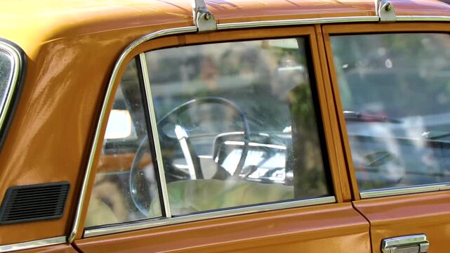 Old Russian orange classic vintage car vehicle in Minsk Belarus.