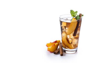 Refreshing peach iced tea in glass with ice cubes and cinnamon isolated on white background. Copy space