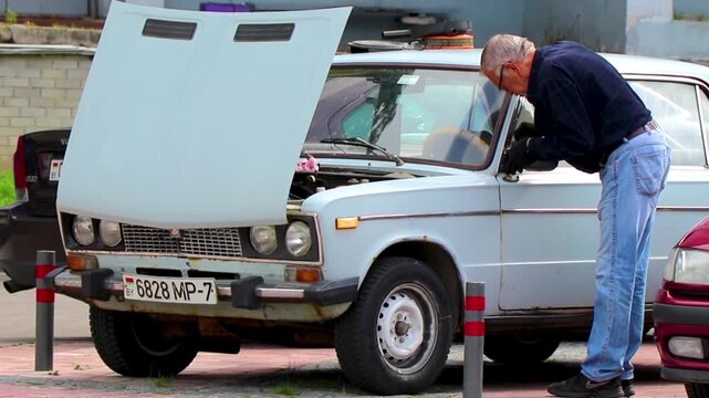 Old Russian white grey classic vintage car vehicle in Belarus.