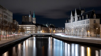 Obraz premium Serene nightscape of a canal reflecting city lights and historic architecture