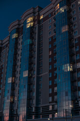 Obraz premium vertical city scape picture of glass skyscraper building long exposure night