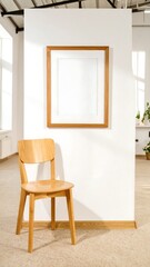 A light-filled room displays a simple wooden chair and an empty picture frame against a clean white wall, bathed in natural light.