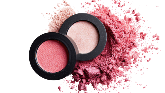 Two round blush compacts, one light and one deep pink, resting atop a cloud of loose powder of similar shade