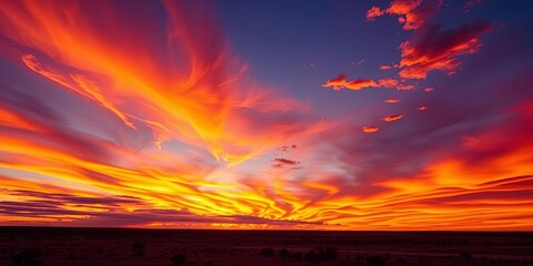Obraz premium Fiery sunset paints Western Australian sky, clouds ablaze with orange and purple hues, WA, light