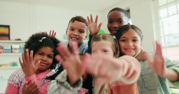 Children, happy and wave with face in classroom, hello and bonding with diversity for education. School kids, smile and group in portrait, excited and learning together with scholarship at academy