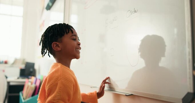 Kid, student and writing on whiteboard in class for lesson, answer to question and problem solving. Black boy, child and drawing shape for demonstration, education activity and solution for knowledge