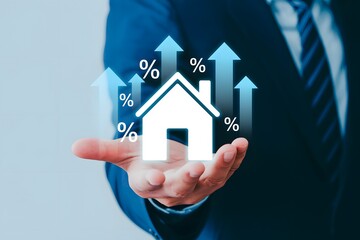 A businessman holding a house icon with percentage signs and arrows pointing upwards in his palm