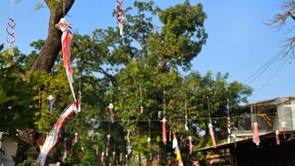 White and red plastic ornaments hanging on the tree in order to celebrate of Indonesia's Independence Day. Euphoria welcoming Indonesian Independence Day on 17 August 2025 .