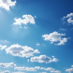 Naklejka premium Expansive bright blue sky with scattered white cumulus clouds and gentle sun rays, a serene and heavenly skyscape background for peaceful concepts